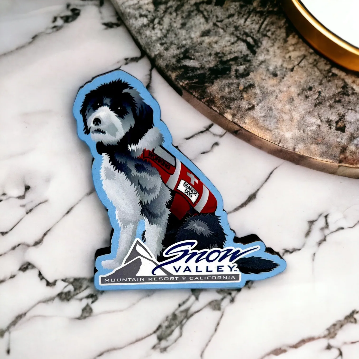 Snow Valley Inyo the Patrol Dog magnet with a white and grey dog in red patrol vest with Snow Valley logo on the bottom